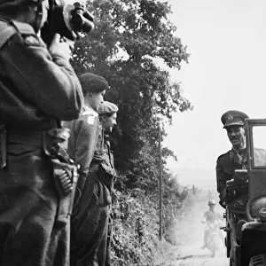 Lieut. Gen. M. C Dempsey, O. B. E M. C (in jeep) talking to Major the Marquis of Hartington