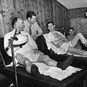 Liverpool footballers in the treatment room at Anfield, seen to by coach Albert Shelley