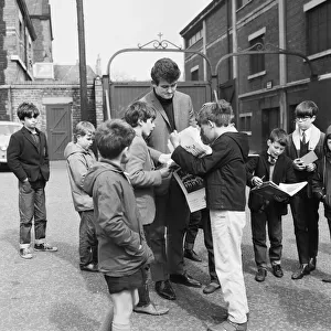 Liverpool goalkeeper Tommy Lawrence sign autographs for fans outside Anfield football