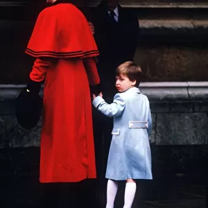 Princess Diana holding Prince William by the hand as they enter St George