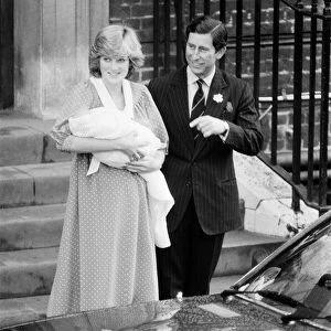 Princess Diana, the Princess of Wales holds her newborn baby son William with husband