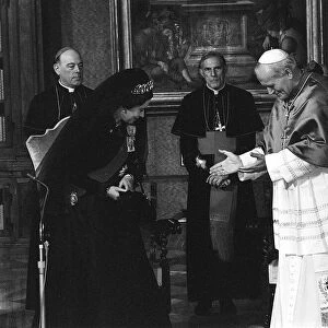 Queen Elizabeth II and the Duke of Edinburgh visit the Vatican to meet Pope John Paul II