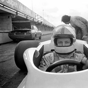 Racing driver John Surtees trying his new car. January 1976 76-00088-001
