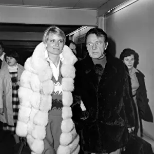 Richard Burton and his wife Susie at London Airport. December 1976