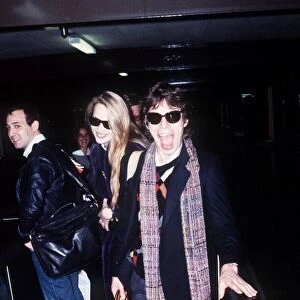 Rolling Stones singer Mick Jagger at London Heathrow Airport with Jerry Hall before