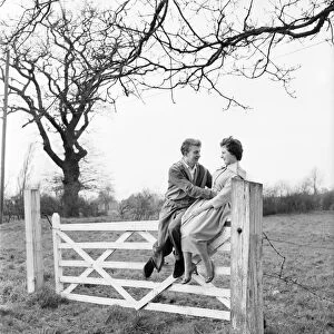 Romantic couple take a stroll in the country side. Richard Camp and Diane Ford. A651-005