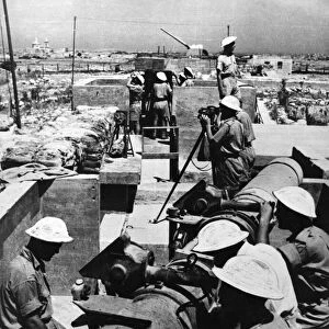 A Scene in Malta as heavy guns of an anti aircraft battery open fire on raiding enemy