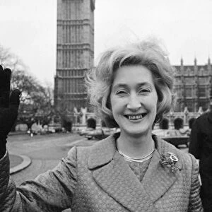 Scottish Nationalist MP Winnie Ewing waves as she stands outside the House of Commons