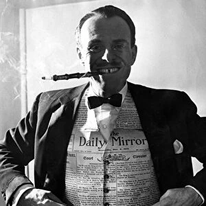 Terry Thomas wearing a waiscoat made from a Daily Mirror. 6th November 1953