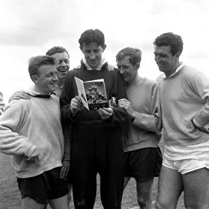 Tottenham Hotspur players reading a copy of the Spurs book called "Spurs 1961"
