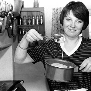 Tv cook Delia Smith at home in kitchen 1981 Mixing with a whisk