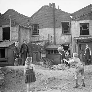 WW2 Children Playing Games Children playing games with a ball beside houses that