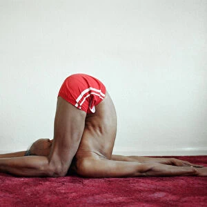 Yoga positions. Position is called The Deaf Mans Pose (Karnapidasana