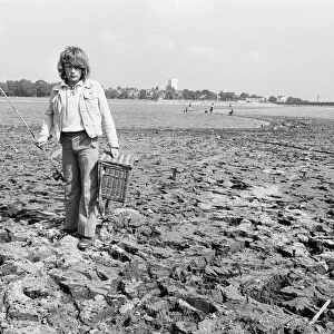 Young boy goes for a spot of fishing at dried out Edgbaston reservoir in Birmingham