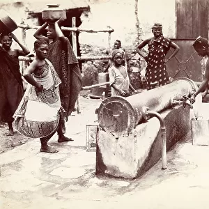 Daily life on the island of Zanzibar: group of women filling the water tanks