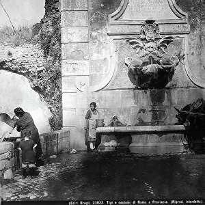 Two women with buckets filled with water by the fountain of Porta Furba, via Tuscolana, while a horse drinks
