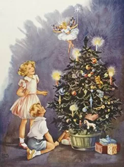 Children with the fairy on top of the Christmas Tree