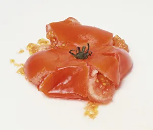Red tomato squashed flat, close up