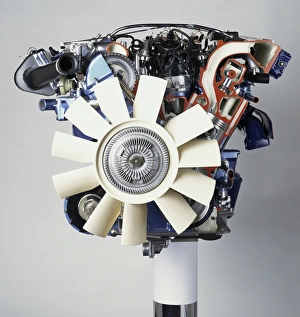 Front view of a V12 petrol engine with white fan at the front Front view of a V12 petrol engine with white fan at the front